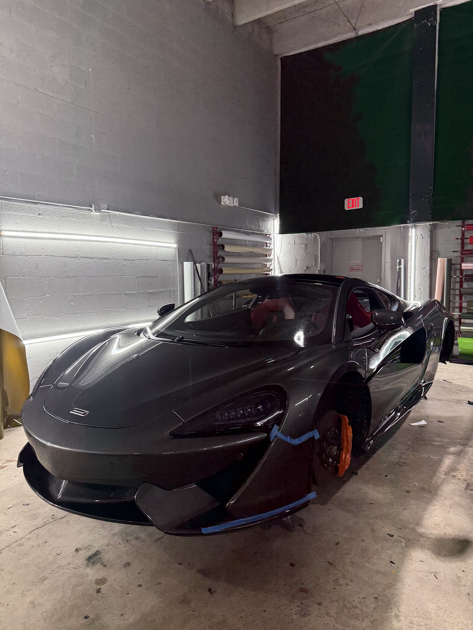 Mechanic working on a vehicle inside the Miami Auto Performance shop